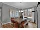 Dining room with wood table, bench, chairs, modern chandelier, and large windows at 19348 Mcbee Ave, Westfield, IN 46074