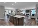 Open-concept kitchen featuring a large island, stainless steel appliances, and seamless flow to the dining and living areas at 19348 Mcbee Ave, Westfield, IN 46074