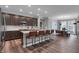 Charming kitchen with island seating, dark cabinets, stainless appliances, and adjacent dining area at 19348 Mcbee Ave, Westfield, IN 46074