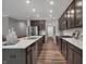 Stylish kitchen featuring dark wood cabinetry, stainless steel appliances, a central island, and an open layout at 19348 Mcbee Ave, Westfield, IN 46074