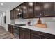 Elegant kitchen featuring stainless steel appliances, dark cabinets, and white subway tile backsplash at 19348 Mcbee Ave, Westfield, IN 46074