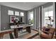 Stylish home office with a unique wooden desk, neutral color scheme, ample natural light and comfortable accent chair at 19348 Mcbee Ave, Westfield, IN 46074