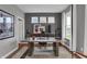 Stylish home office with a unique wooden desk, neutral color scheme, and ample natural light from large windows at 19348 Mcbee Ave, Westfield, IN 46074