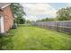 A spacious, well-maintained backyard featuring lush green grass and a sturdy wooden fence for privacy and security at 22620 Lamong Rd, Sheridan, IN 46069