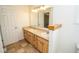 Bathroom featuring double sinks, neutral walls, vanity, and decorative mirror at 22620 Lamong Rd, Sheridan, IN 46069