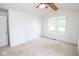 Well-lit carpeted bedroom featuring a ceiling fan and a large window for natural light at 22620 Lamong Rd, Sheridan, IN 46069