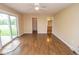 Bedroom with wood floors, neutral walls, ceiling fan, sliding glass door, and entry doors at 22620 Lamong Rd, Sheridan, IN 46069