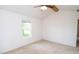 Bright bedroom boasts vaulted ceiling, carpet, and large window with outdoor view at 22620 Lamong Rd, Sheridan, IN 46069