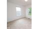 A simple bedroom with neutral carpet, white walls, and natural light from two windows at 22620 Lamong Rd, Sheridan, IN 46069