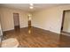 Bedroom with wood floors, neutral walls, ceiling fan, and two entry doors at 22620 Lamong Rd, Sheridan, IN 46069