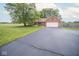 Charming brick home with manicured lawn, paved driveway, and an attached two car garage at 22620 Lamong Rd, Sheridan, IN 46069