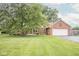 Charming brick home with manicured lawn, paved driveway, attached two car garage and mature trees at 22620 Lamong Rd, Sheridan, IN 46069