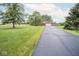 Charming brick home with lush green lawn, paved driveway, and mature trees at 22620 Lamong Rd, Sheridan, IN 46069
