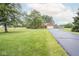 Charming brick home with lush green lawn, paved driveway, and mature trees at 22620 Lamong Rd, Sheridan, IN 46069