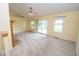 Neutral living room featuring a ceiling fan, carpet, and sliding glass door to the outdoors at 22620 Lamong Rd, Sheridan, IN 46069