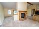 Inviting living room with fireplace, neutral carpet, and open layout leading to the kitchen at 22620 Lamong Rd, Sheridan, IN 46069