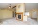 Living room featuring high ceilings, a fireplace with wood mantle, neutral carpet, and natural light at 22620 Lamong Rd, Sheridan, IN 46069