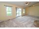 Bright living room with vaulted ceiling, ceiling fan, sliding glass door to the yard and neutral carpet at 22620 Lamong Rd, Sheridan, IN 46069