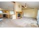 Open concept living space with fireplace, view of kitchen, and sliding doors to the backyard at 22620 Lamong Rd, Sheridan, IN 46069