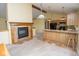 Spacious living space showcasing a fireplace and open flow into the kitchen with breakfast bar at 22620 Lamong Rd, Sheridan, IN 46069