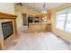 Bright open concept living space features fireplace, kitchen with breakfast bar, and large window at 22620 Lamong Rd, Sheridan, IN 46069