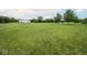 Spacious green property featuring a well-maintained lawn and mature trees, offering a tranquil and expansive outdoor setting at 22620 Lamong Rd, Sheridan, IN 46069