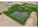 Aerial view of a pond surrounded by a lush tree line, highlighting the property's natural beauty at 2708 N 400 E, Greenfield, IN 46140