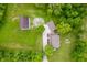 Aerial view of property featuring the home, outbuildings, mature trees, and well-maintained lawn at 2708 N 400 E, Greenfield, IN 46140