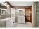 Bright bathroom featuring double vanity with white cabinetry and decorative wood look wall tile at 2708 N 400 E, Greenfield, IN 46140