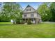 Charming two-story home with a large front yard and beautiful landscaping in a peaceful, wooded setting at 2708 N 400 E, Greenfield, IN 46140