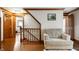 Hallway featuring hardwood floors, staircase and an armchair at 2708 N 400 E, Greenfield, IN 46140
