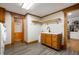 Spacious laundry room with wooden cabinets, utility sink, corner shelf and nearby pantry at 2708 N 400 E, Greenfield, IN 46140