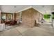 Outdoor patio with brick columns, rocking chairs, dining set, and covered roof at 2708 N 400 E, Greenfield, IN 46140