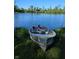 Old fishing boat pulled up on the grass next to a beautiful pond on a sunny day at 2708 N 400 E, Greenfield, IN 46140
