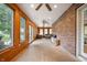 Long sunroom featuring lots of natural light, with brick accent wall and exterior views at 2708 N 400 E, Greenfield, IN 46140