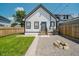 View of backyard with new fence and landscaping; gravel firepit area, new siding and windows at 2909 E Michigan St, Indianapolis, IN 46201