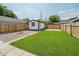 Backyard featuring a gravel area with fire pit and grass with a storage shed at 2909 E Michigan St, Indianapolis, IN 46201