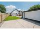Wide shot of the spacious backyard with large parking pad, shed, and new fence at 2909 E Michigan St, Indianapolis, IN 46201