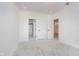 Empty bedroom with neutral carpet and multiple doors leading to closets and bathroom at 2909 E Michigan St, Indianapolis, IN 46201