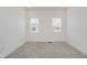 An empty carpeted bedroom with recessed lights and two windows at 2909 E Michigan St, Indianapolis, IN 46201