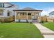Charming home with a inviting front porch, and well-manicured lawn, perfect for relaxing outdoors at 2909 E Michigan St, Indianapolis, IN 46201