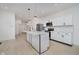 Bright modern kitchen with stainless steel appliances, white cabinets, and a large island with pendant lighting at 2909 E Michigan St, Indianapolis, IN 46201
