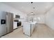 Modern kitchen features stainless appliances, white cabinets and island with elegant pendant lighting at 2909 E Michigan St, Indianapolis, IN 46201