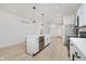 Modern kitchen features white cabinets, stainless appliances, island with sink and stylish pendant lighting at 2909 E Michigan St, Indianapolis, IN 46201