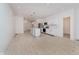Bright, open-concept living and kitchen area featuring modern appliances, white cabinets, and light wood flooring at 2909 E Michigan St, Indianapolis, IN 46201