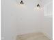 View of a blank room with new, light-colored flooring and modern lighting at 2909 E Michigan St, Indianapolis, IN 46201