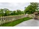 Back yard features wood deck, privacy fence, lawn and beautiful view of the neighborhood lake and waterway at 2949 River Bay N Dr, Indianapolis, IN 46240