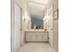 Well-lit bathroom vanity area featuring a large mirror and bright sconces at 2949 River Bay N Dr, Indianapolis, IN 46240