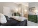 A serene bedroom with a glimpse into the bathroom, decorated with green accent dressers at 2949 River Bay N Dr, Indianapolis, IN 46240