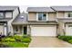 Inviting home featuring a two-car garage, manicured lawn, and charming landscaping at 2949 River Bay N Dr, Indianapolis, IN 46240